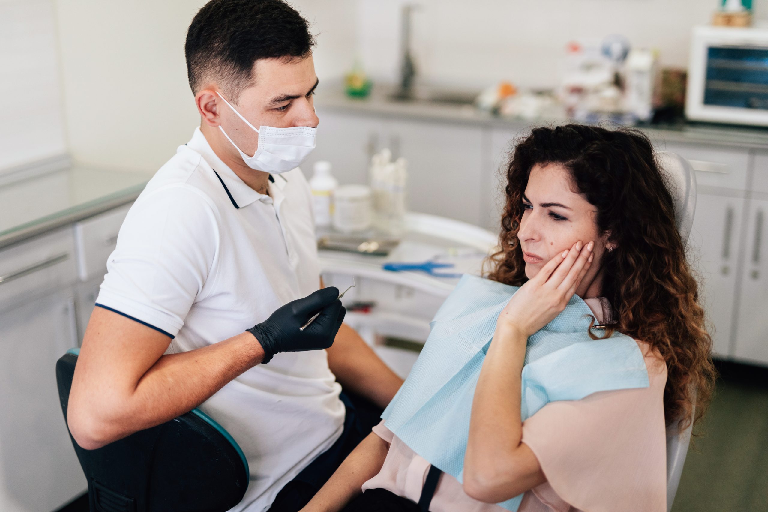 Dentist performing a routine dental checkup on a patient